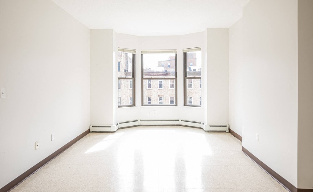 an empty room with three windows in it