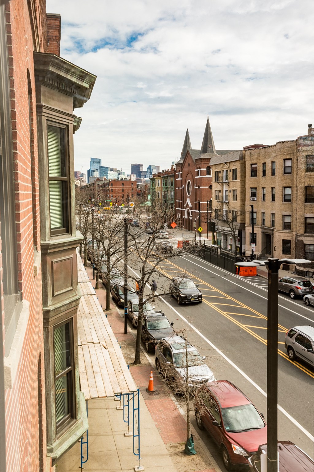 a view of a city street from a balcony of a building