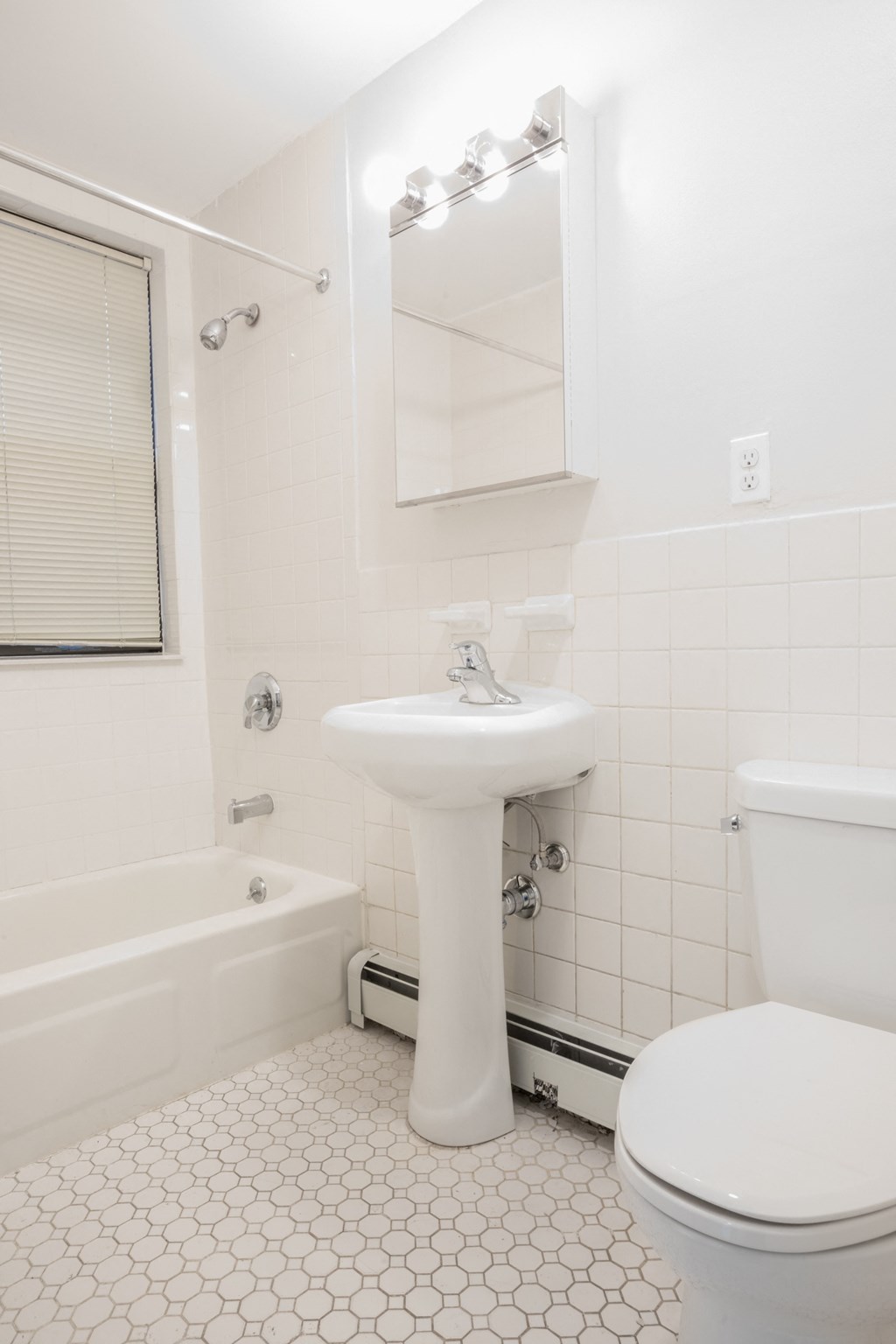 a white bathroom with a sink and a toilet
