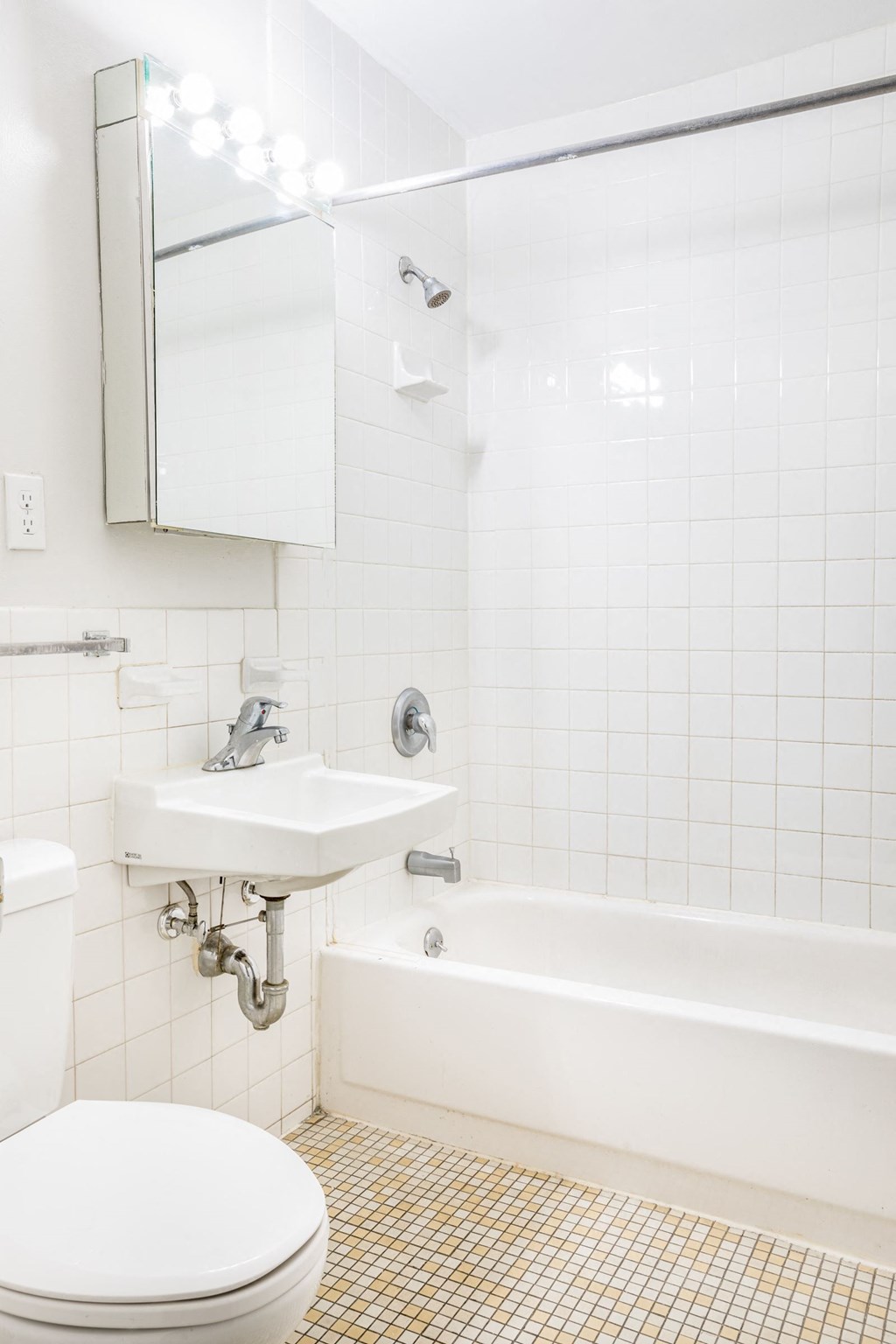 a white bathroom with a sink toilet and tub