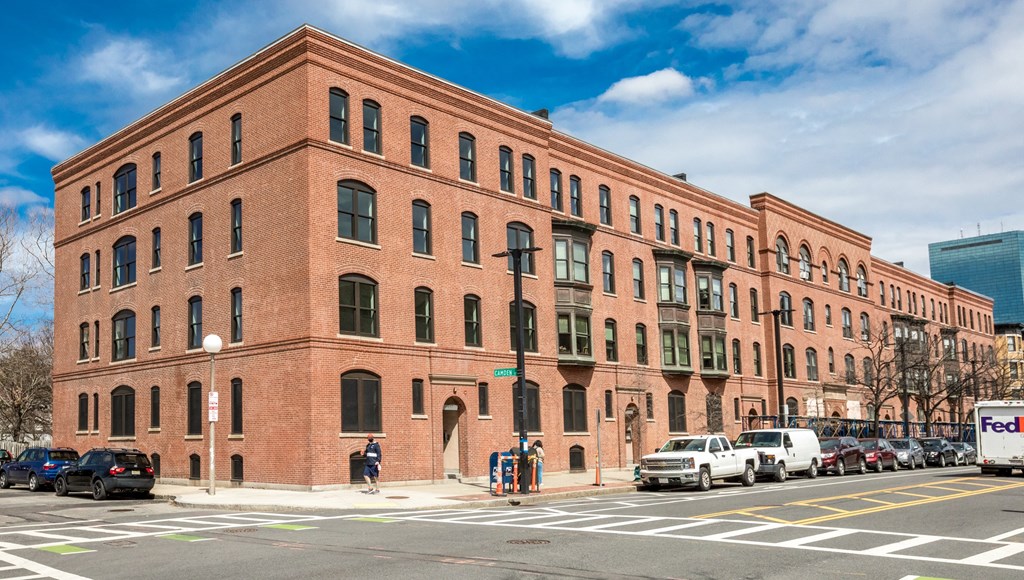 a large brick building on the corner of a city street