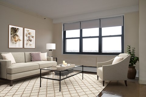 A living room with a couch, chair, and coffee table.