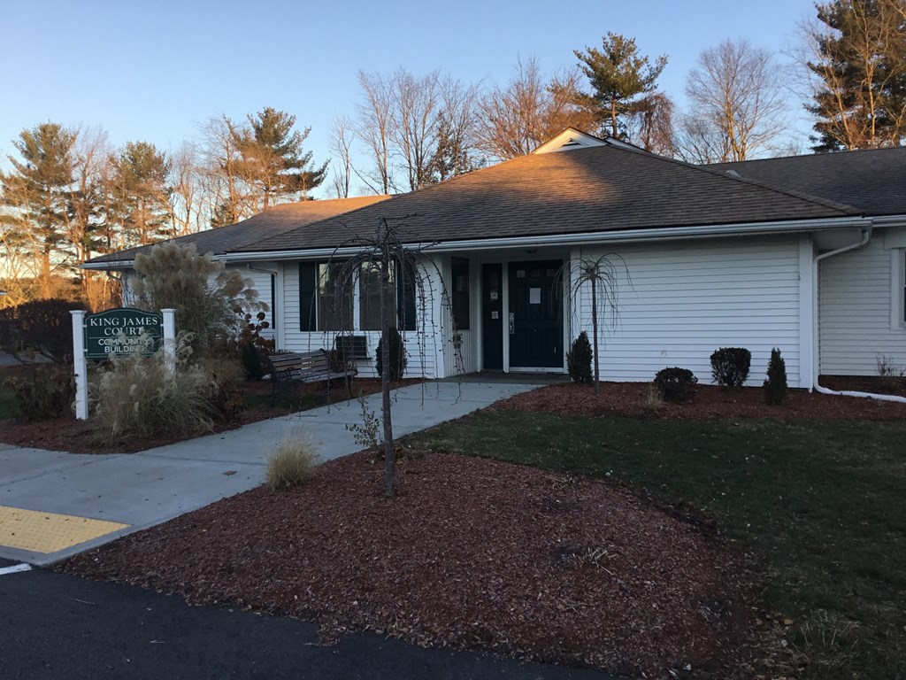 a white house with a sidewalk in front of it