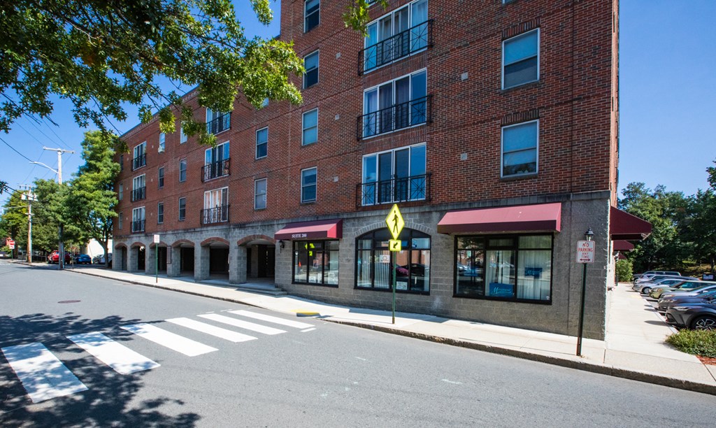 a large brick building on the corner of a street