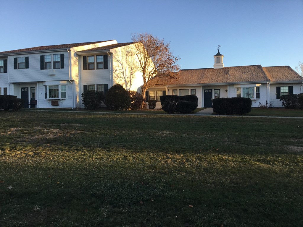 a view of a house with a yard in front of it