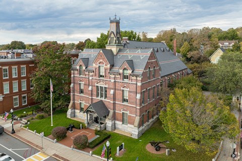 A large red brick building with a tower on top.