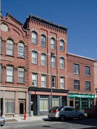 a brick building on the corner of a city street