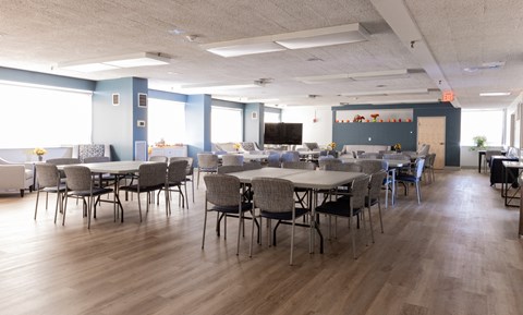 A conference room with a long table and chairs.