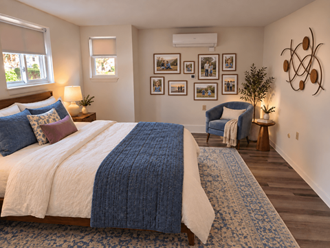 A bedroom with a large bed and a blue and white blanket.