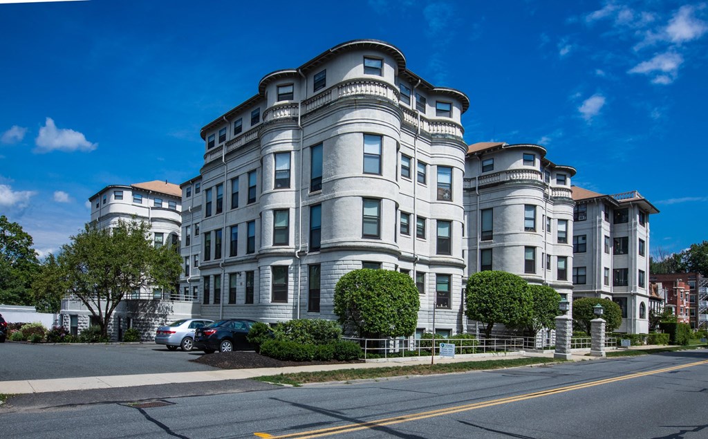 an apartment building on the corner of a city street