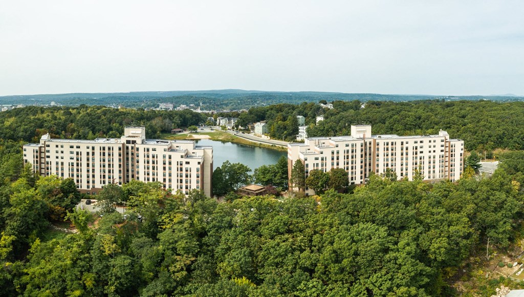 an aerial view of a city with a lake and buildings
