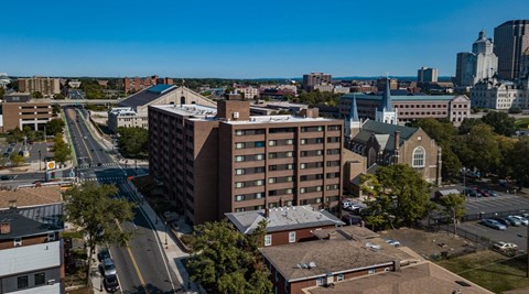 an aerial view of a city with a building and a street