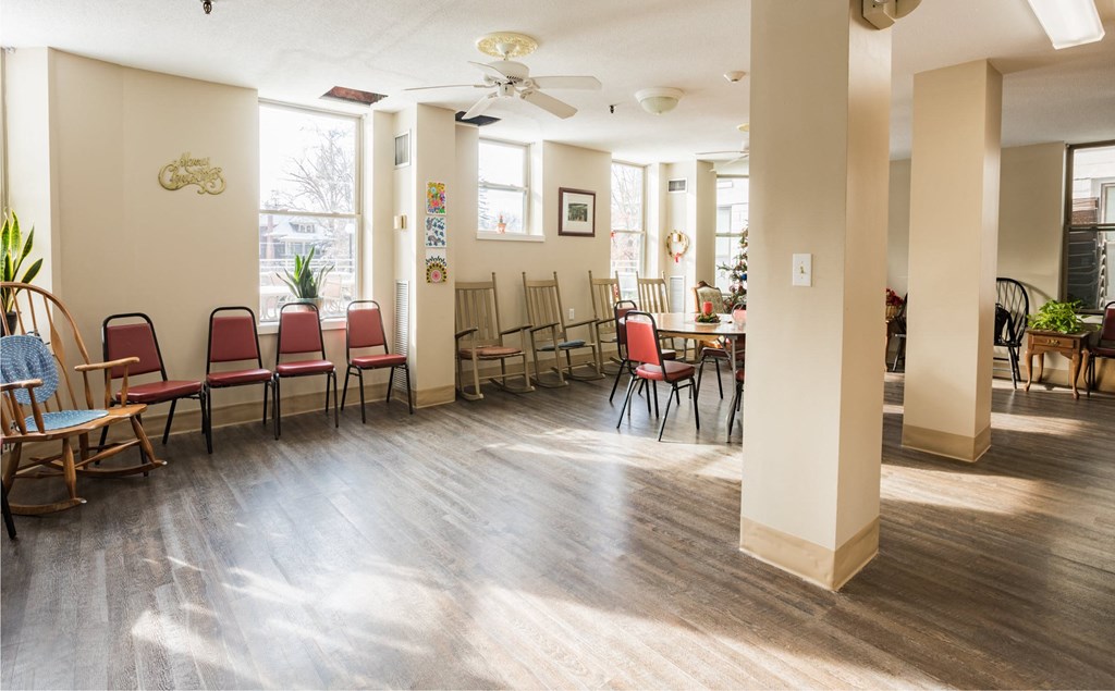 a dining room with chairs and tables and a ceiling fan