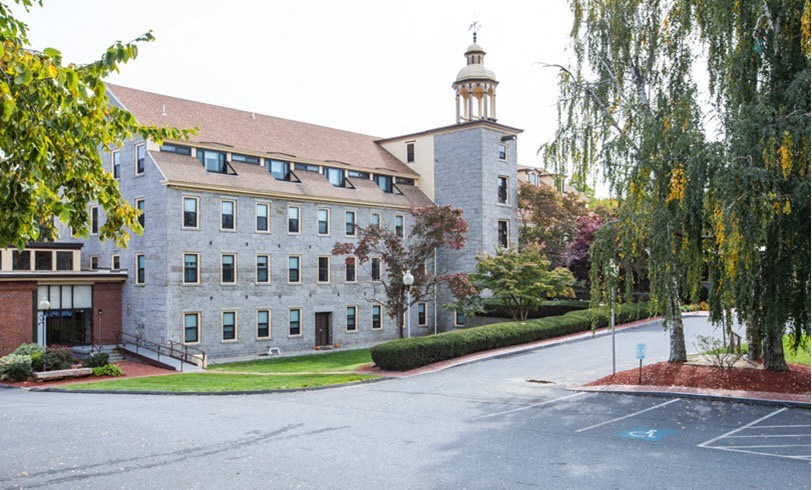a building on the side of a street with trees