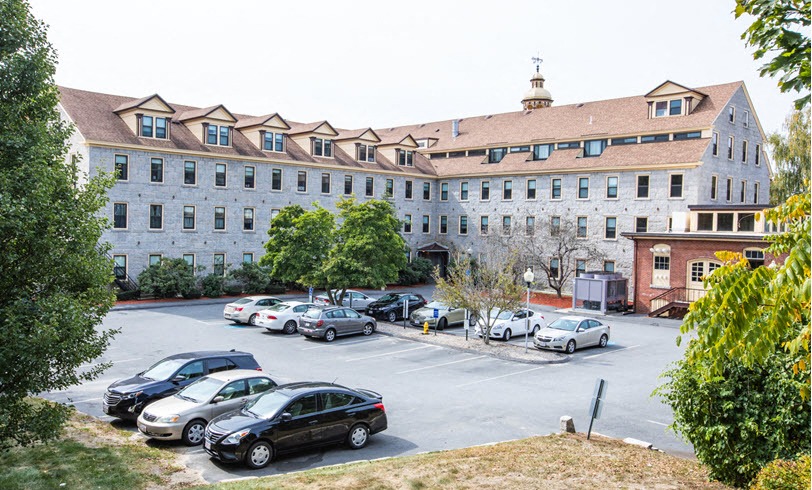 a parking lot with cars in front of a large building