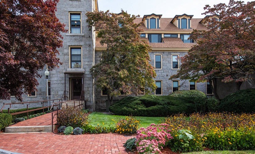 an apartment building with a garden in front of it