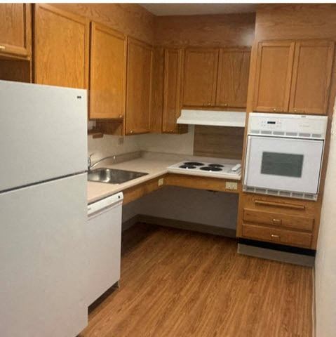 a small kitchen with a stove and a refrigerator