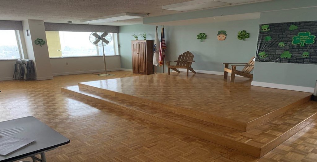 an empty room with a wooden floor and a table