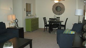an open living room and dining room with a table and chairs
