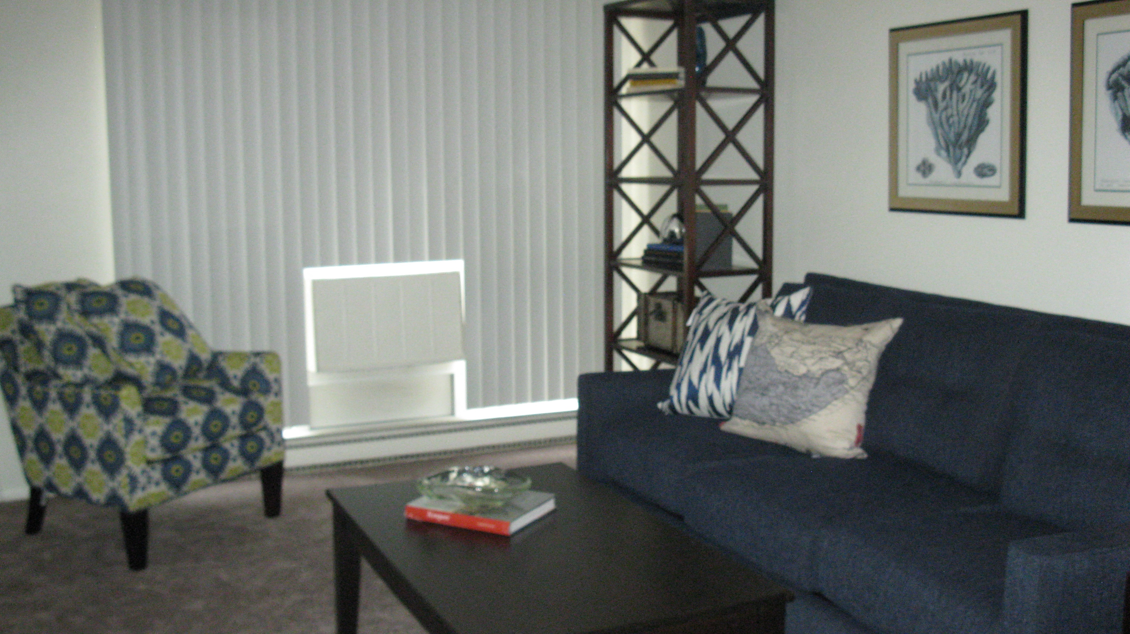 a living room with a blue couch and a coffee table