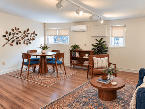 A living room with a wooden floor and furniture.