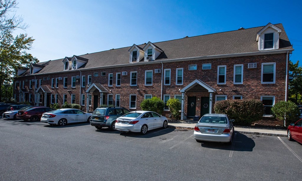 a large brick building with cars parked in front of it