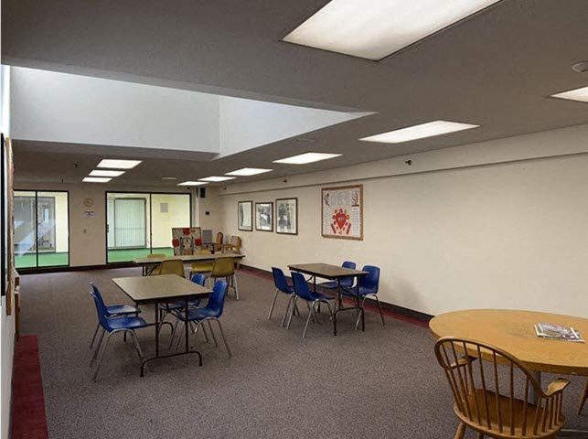 a large room with tables and chairs in it