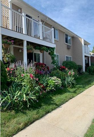 a house with a flower garden in front of it