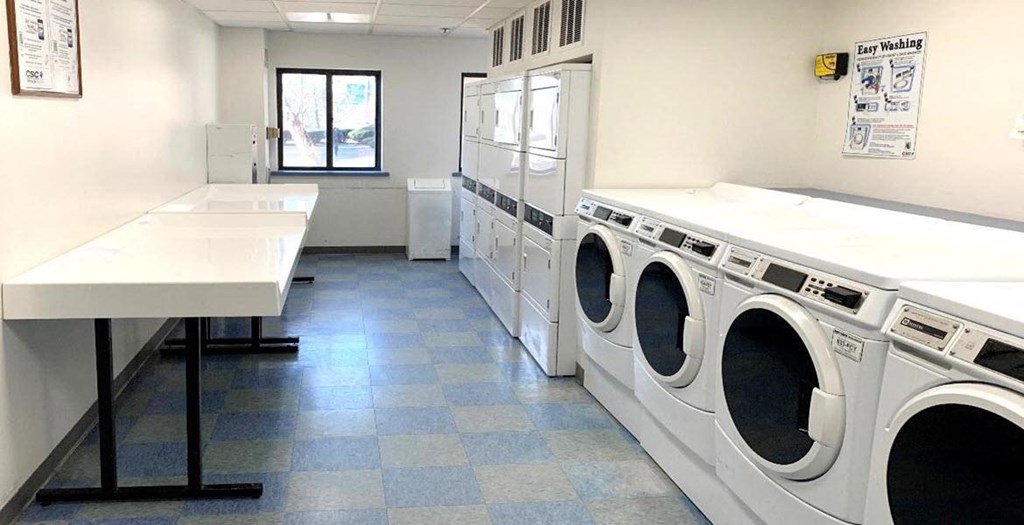 a laundry room with washing machines and sinks