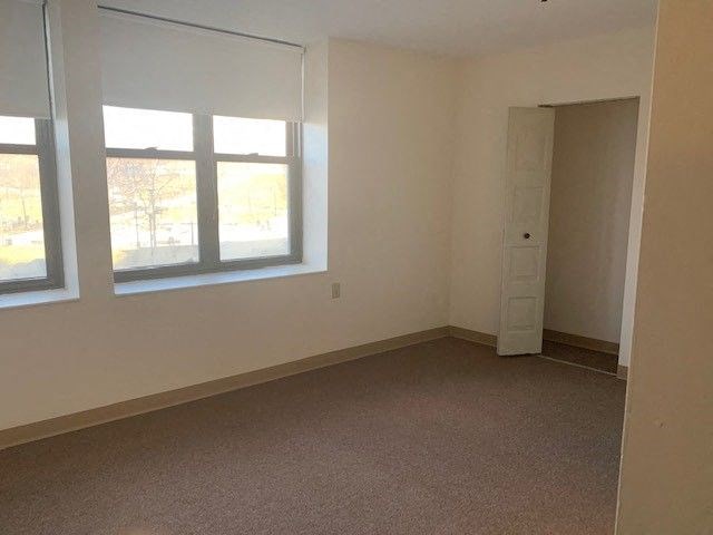 an empty room with a window and a door