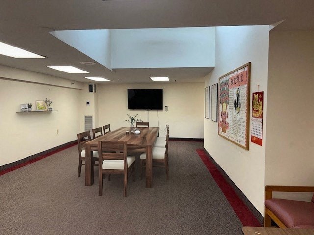 a dining room with a wooden table and chairs