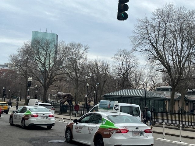 a busy city street with cars and a traffic light