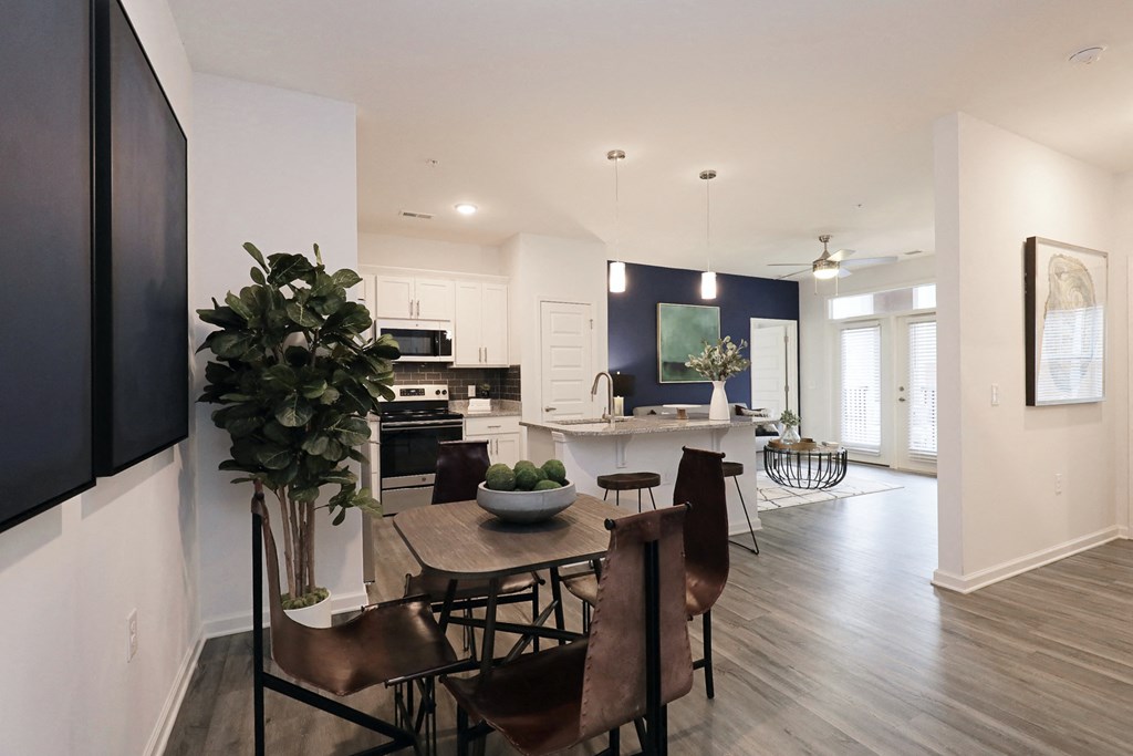 an open kitchen and dining room with a table and chairs