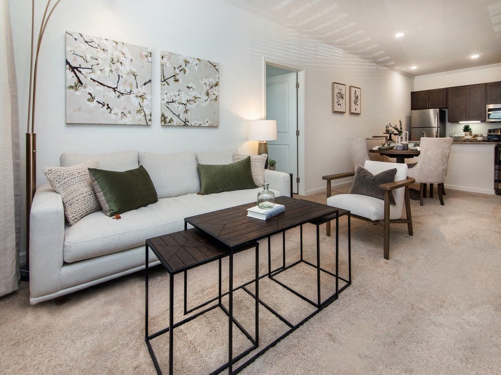 a living room with a white couch and a wooden coffee table at Ardmore at the Trail, Indian Trail, 28079