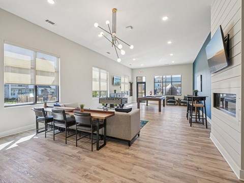 A modern living room with a dining table and chairs.