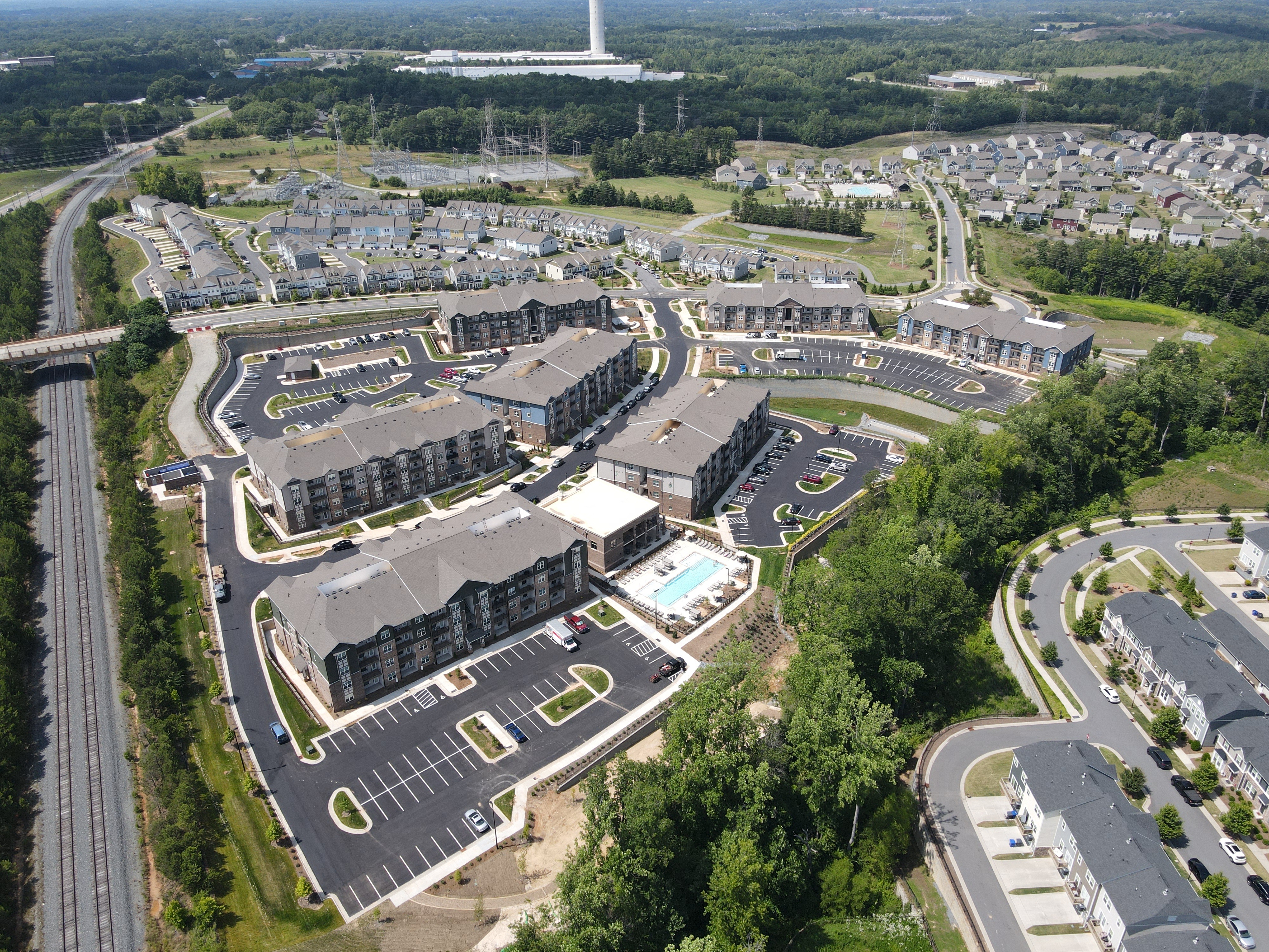 an aerial view of an apartment complex with a highway in the background  at Ardmore at Bryton, Huntersville, North Carolina