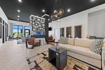 A living room with a large couch, a coffee table, and a TV.