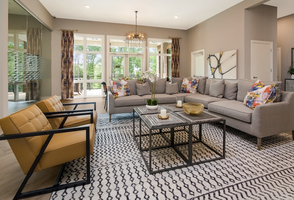 a living room filled with furniture and a large window