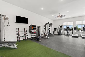 A spacious home gym with a variety of equipment.