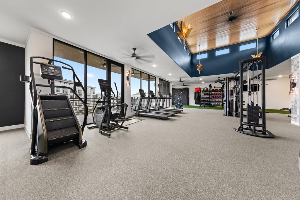 A gym with treadmills, weights, and exercise equipment at Views at Flowers Apartments, Clayton, North Carolina