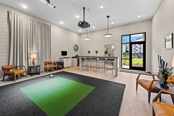 A modern living room with a green rug and wooden furniture at Views at Flowers Apartments, Clayton