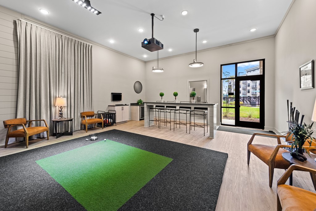 A modern living room with a green rug and wooden furniture at Views at Flowers Apartments, Clayton 27527
