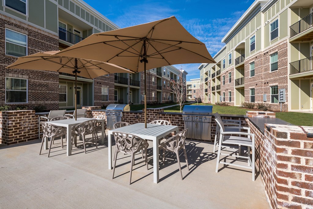 our apartments offer a patio with tables and chairs and umbrellas