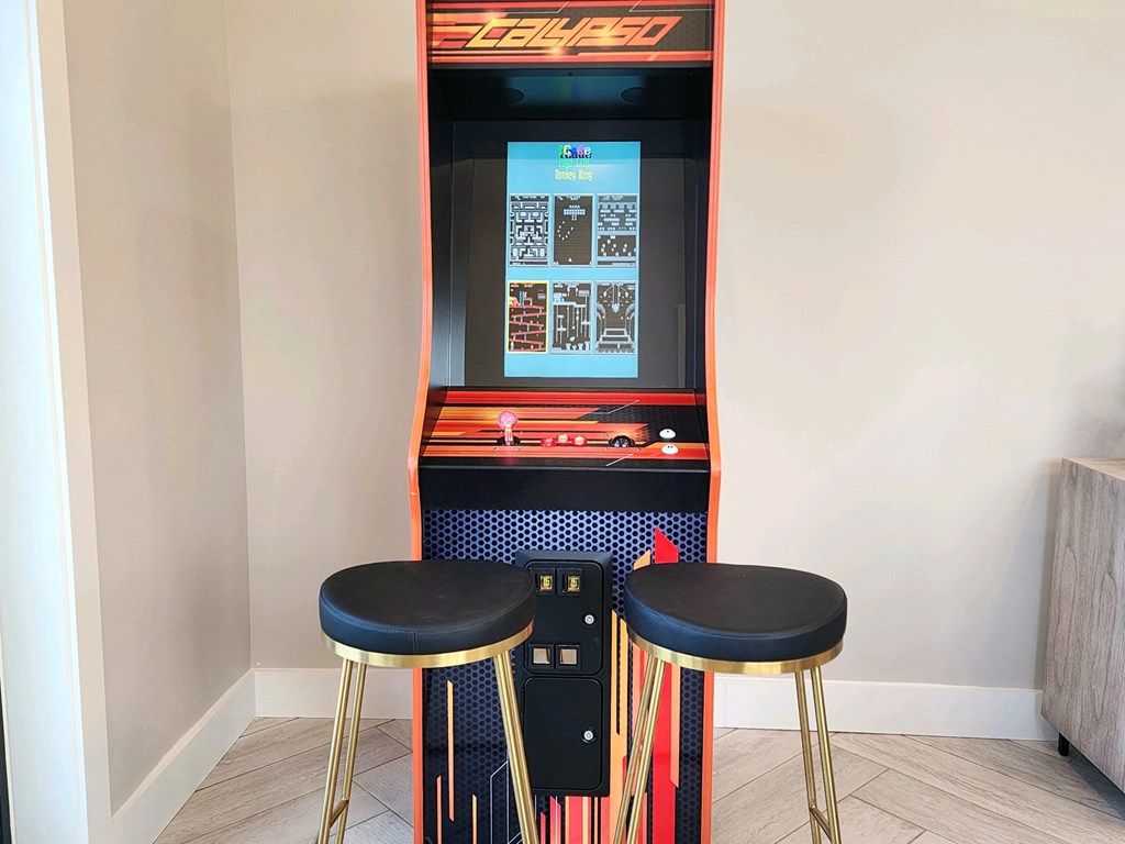 Game machine in a room with two stools at Ardmore at Topside in Louisville, TN 37777