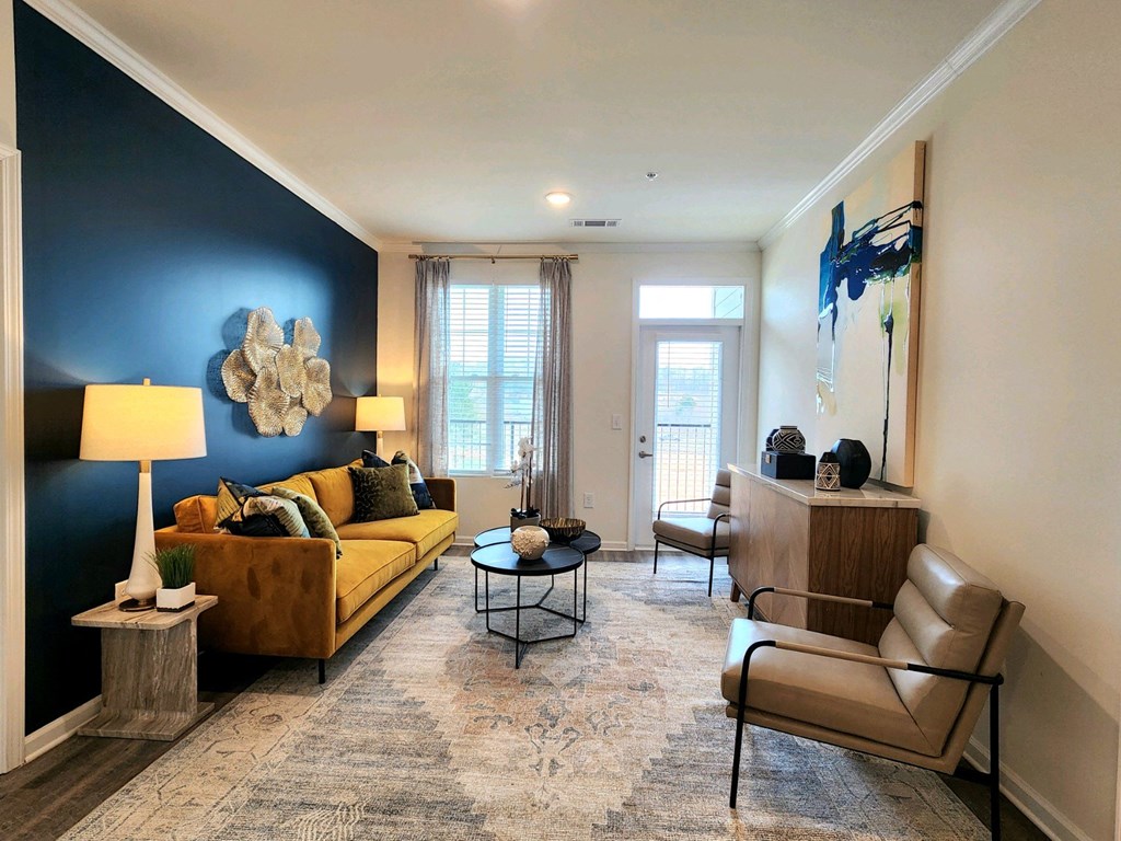 Living room with a blue accent wall and a yellow couch at Ardmore at Topside in Louisville, TN 37777