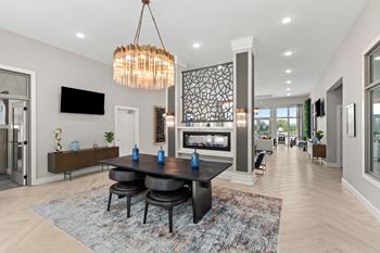 A modern dining room with a black table and chairs.