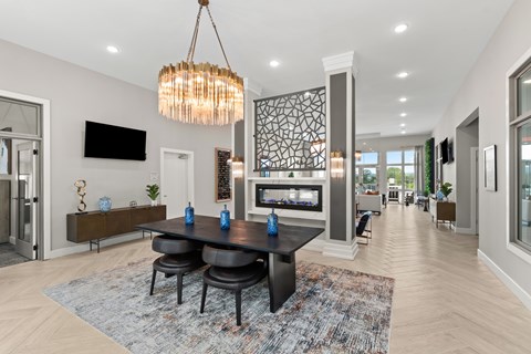 A modern dining room with a black table and chairs.
