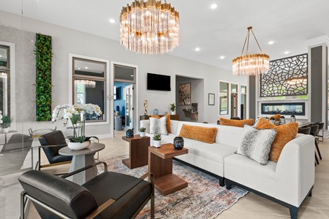 A modern living room with a white sofa and a large chandelier.