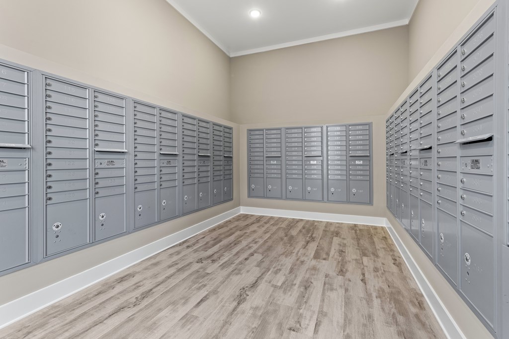 A room with a row of mailboxes on the wall at Views at Flowers Apartments, Clayton 27527