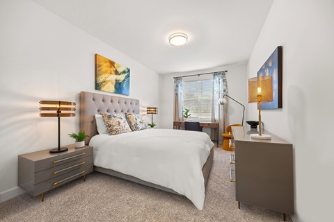 A bedroom with a white bed and a brown cabinet.